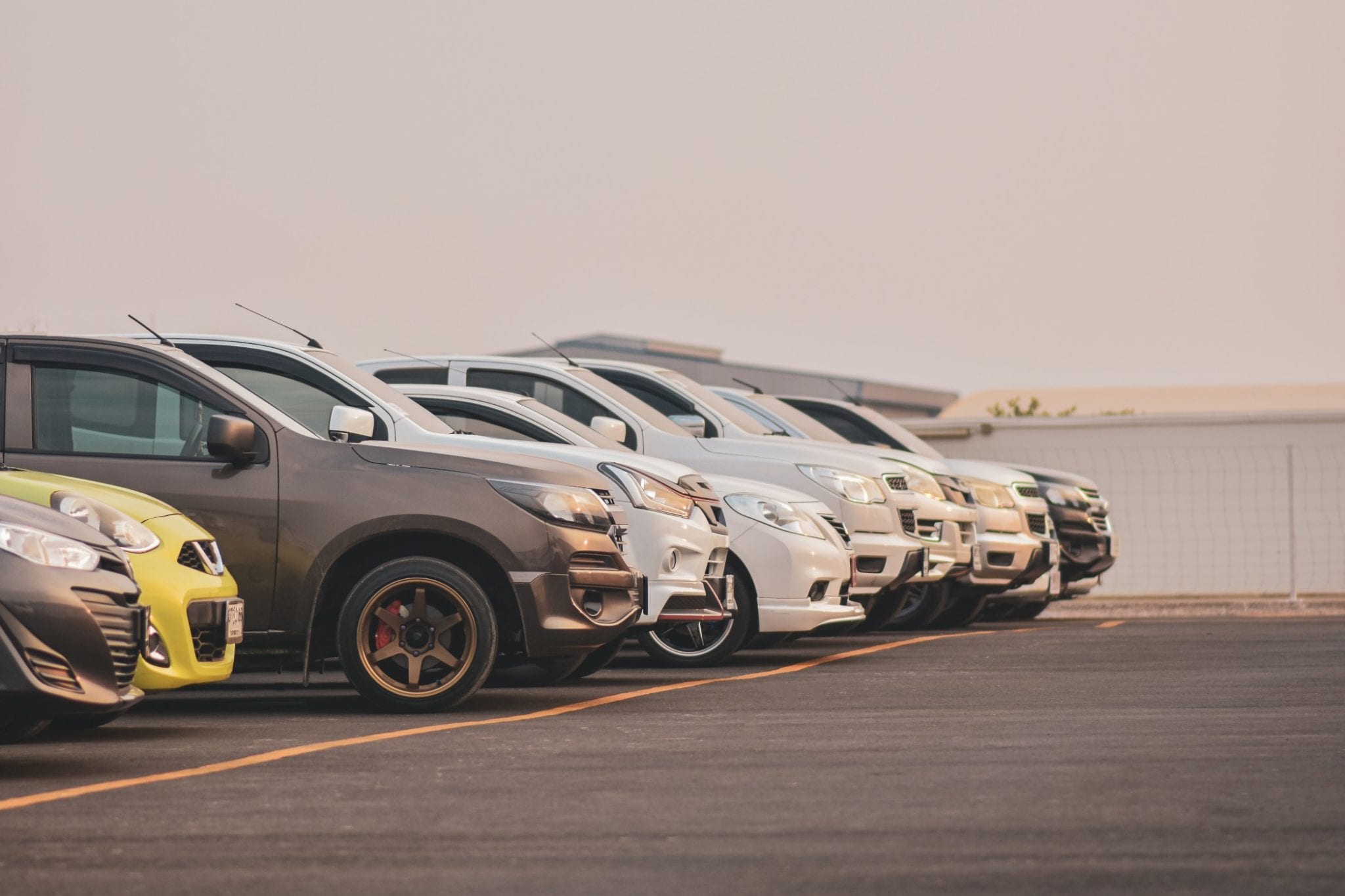parked cars in a row at a car auction cars parked at a private auto auction